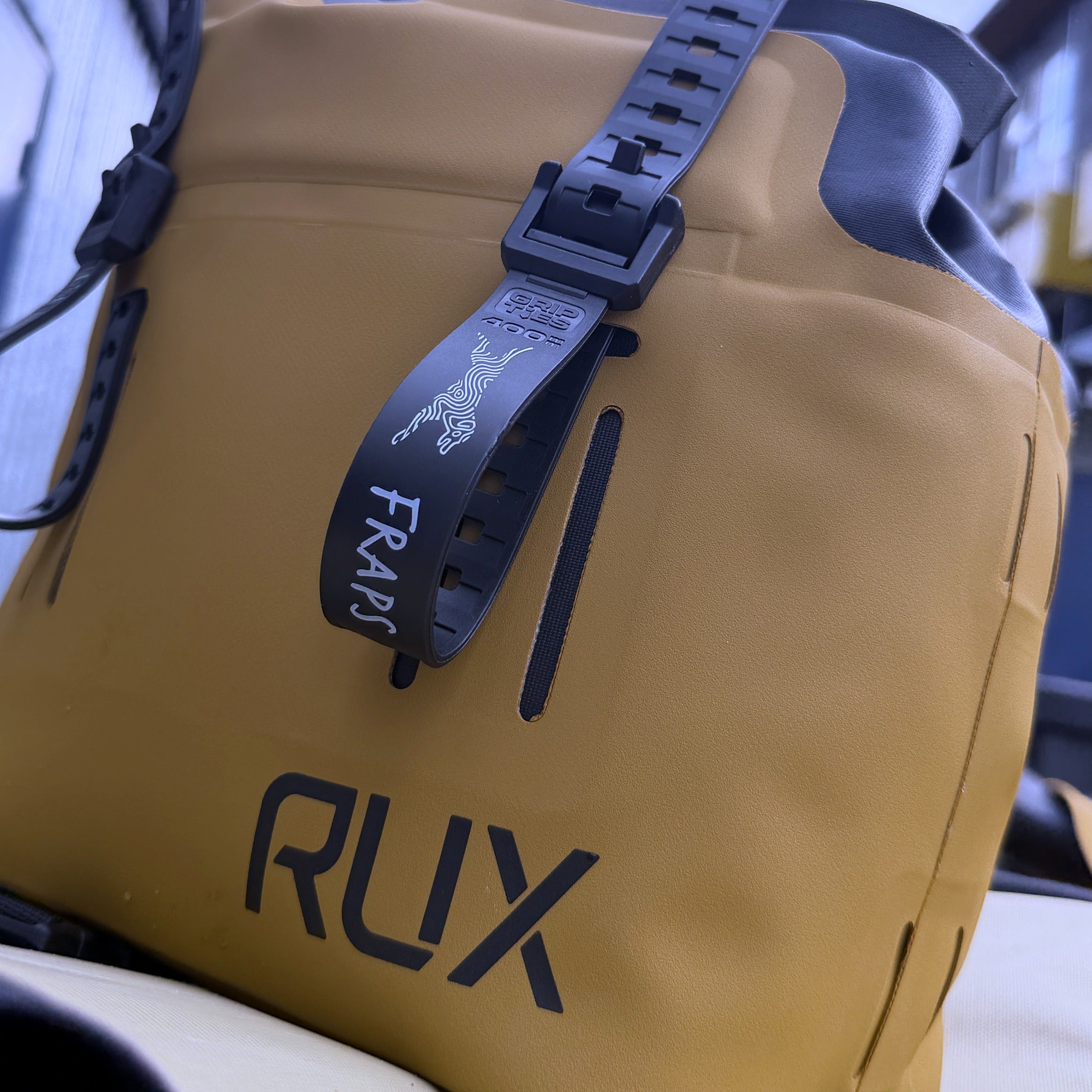 FRAPS STRAP cinched through a RUX bag